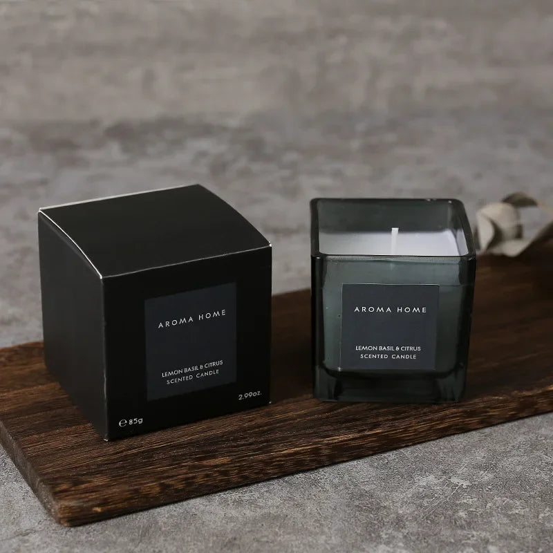شمعة معطرة في وعاء زجاجي مربع وعتيق.