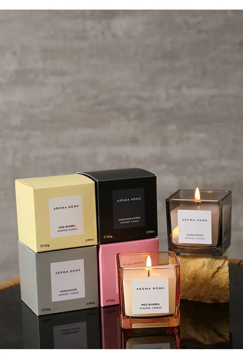 شمعة معطرة في وعاء زجاجي مربع وعتيق.